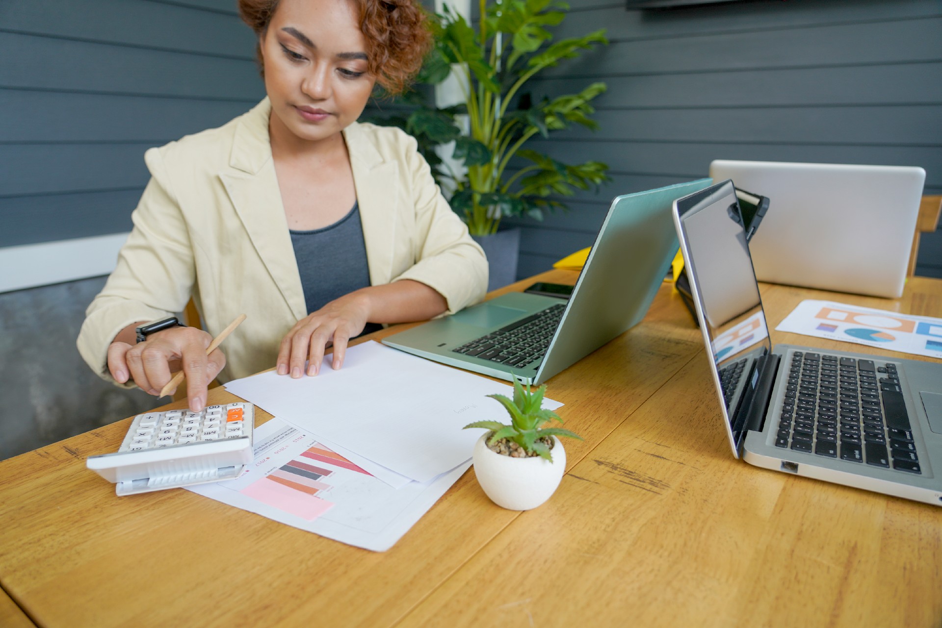 Woman Using Calculator For Taxes And Budget At Home. Financial planning Concepts.