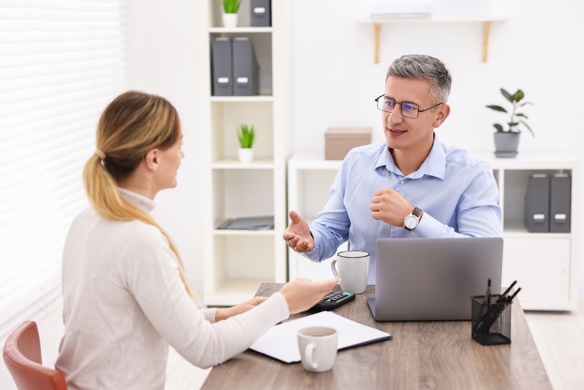 Banker working with client at table in office